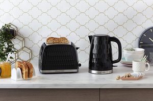 The black Russell Hobbs 26051 Honeycomb Kettle on display next to a matching toaster.